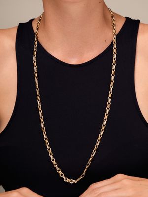 a woman wearing a black tank top and a gold chain necklace
