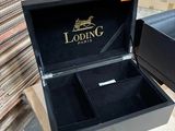 a black box with a gold logo on it and a black box with a gold logo on it