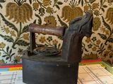 a black iron sitting on top of a table next to a calendar