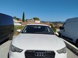 an audi car parked in a parking lot next to a van