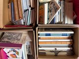 boxes of books are stacked on top of each other in a room