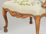 pair of early 20th century french carved walnut armchairs with floral upholstered cushions