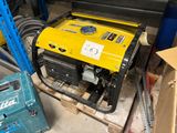 a yellow generator sitting on a pallet in a garage