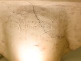 a close up of a statue of a person with writing on it