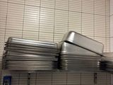 a stack of pans sitting on a shelf in a kitchen