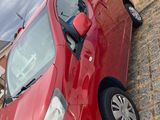 a red van that is parked on the side of the road
