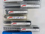 a lot of pens that are in a plastic container
