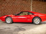 a red sports car parked in front of a brick wall