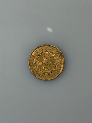 a gold coin sitting on top of a white surface