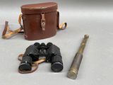 two binoculars and a pair of binoculars on a table