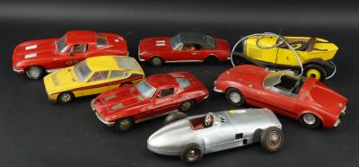 several toy cars are lined up in a row on a black surface