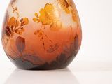 a glass vase with a floral design on it