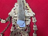 a silver metal object with a blue piece of paper on it