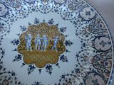 a plate with a picture of a group of people on it
