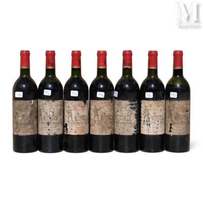 six bottles of wine are lined up in a row on a white surface