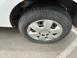 a white car with a flat tire in a parking lot