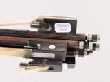 a close up of a violin bow with a stick in it