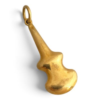 a close up of a gold violin charm on a white background