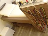 a table with a bunch of wires on it in a room