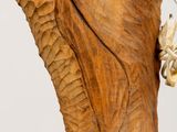 a statue of an elephant that is carved into a tree