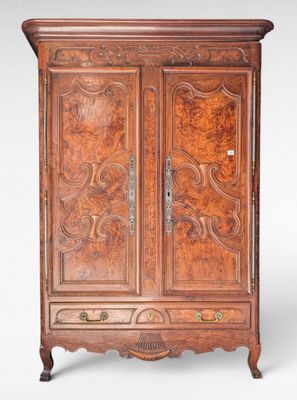 an old wooden armoire with carvings on the doors and drawers