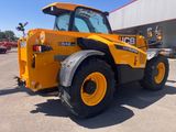 a yellow tractor that is parked in a parking lot