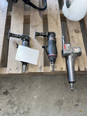 a lot of tools sitting on a pallet on the floor