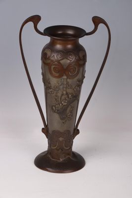 a metal vase with a handle on a white background