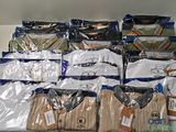 a lot of men ' s shirts on a shelf in a store