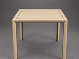 a small table with a square top on a grey background