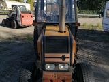 a tractor that is parked in the dirt