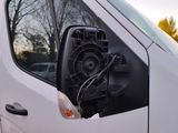 a white van that has a speaker in the side of it