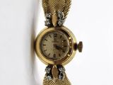 an image of a close up of a wrist watch on a white surface