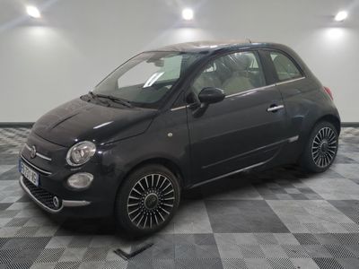 a picture of a small black car parked in a garage