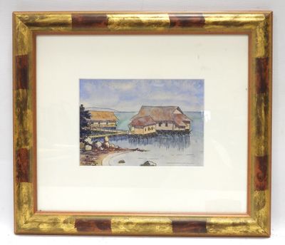 framed watercolor painting of a boathouse on the shore of a lake