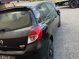 a black car parked in a parking lot next to a building