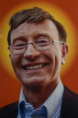 a picture of a man with glasses smiling for the camera