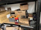 many boxes on a shelf in a room full of stuff