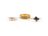 a close up of two gold rings with black stones on them