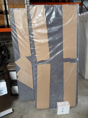a large piece of cardboard sitting on the floor in a warehouse
