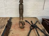 a wooden table with tools on it and a statue on top of it