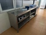 a kitchen with a stainless steel counter top and a window