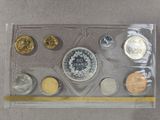 an assortment of silver and gold coins in a clear plastic case