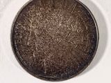 a coin that is sitting on a white surface
