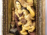an old picture of a woman holding a baby in a wooden frame