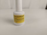 a close up of a bottle of nail polish on a white surface