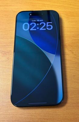a close up of a cell phone on a wooden table