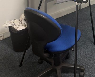 a desk with a chair and a laptop on it