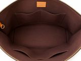 the inside of a brown purse with a zipper on it