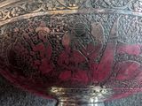 a silver bowl with a design on it on a table